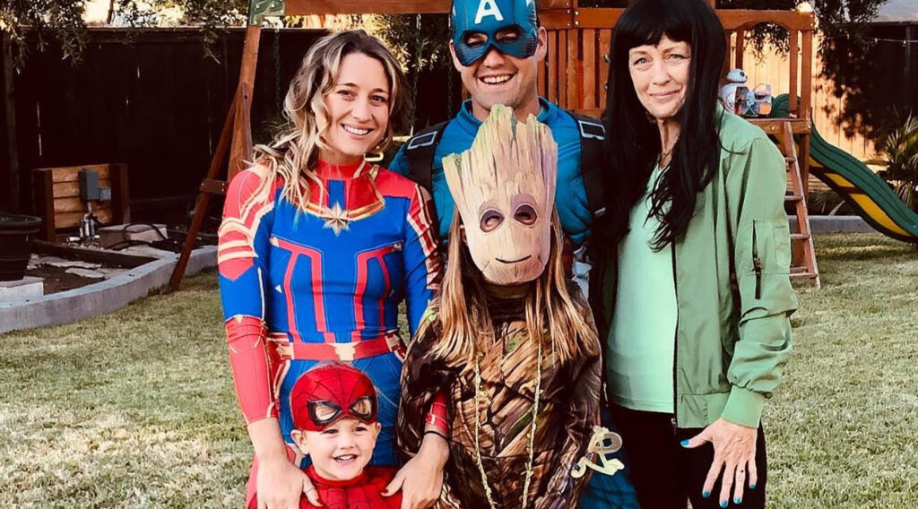 family in backyard dressed up in costumes for halloween